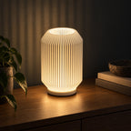 Ribelle Glow 3D printed table lamp (15 cm) glowing warmly at night